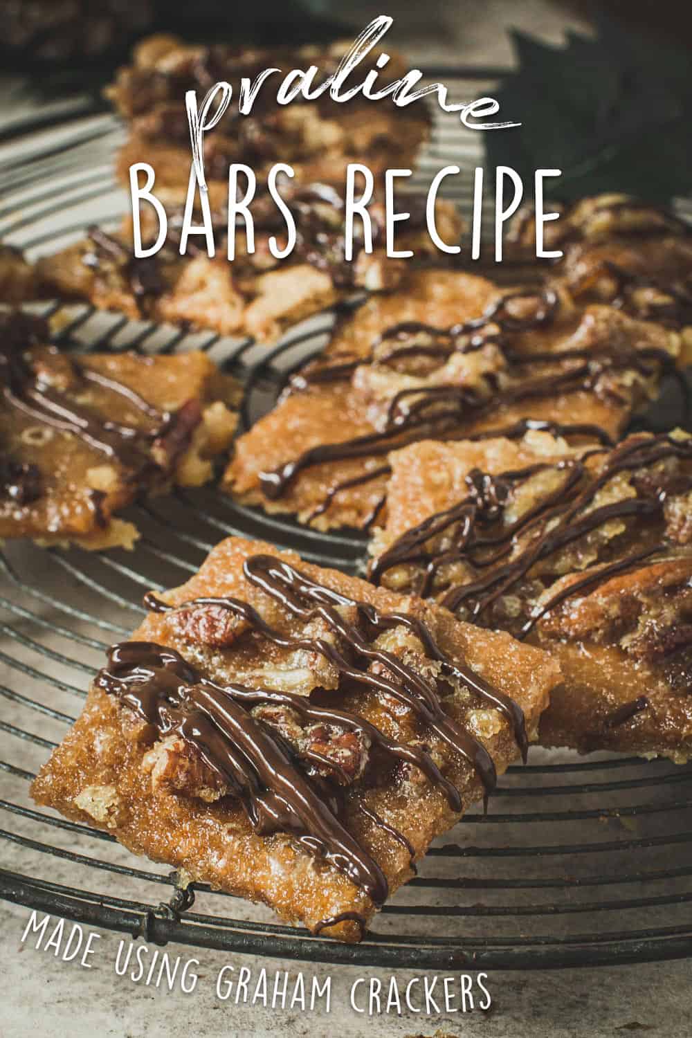 Praline bars on a round wire rack drizzled in chocolate.