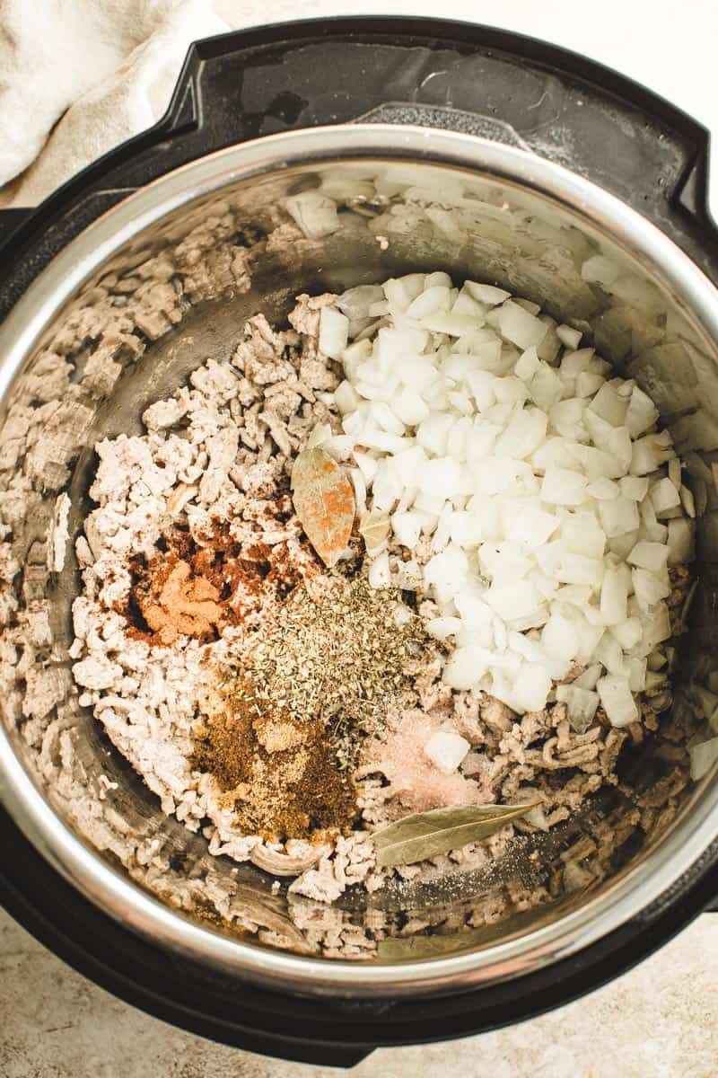 Sautéed picadillo ingredients with spices in the Instant Pot.