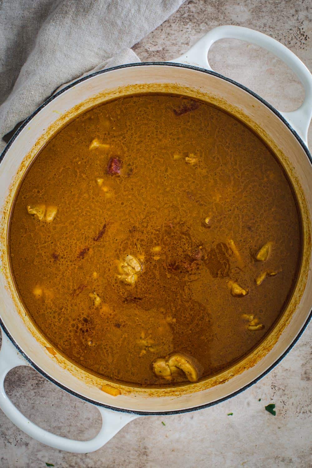 Coconut chicken curry in white Dutch Oven.