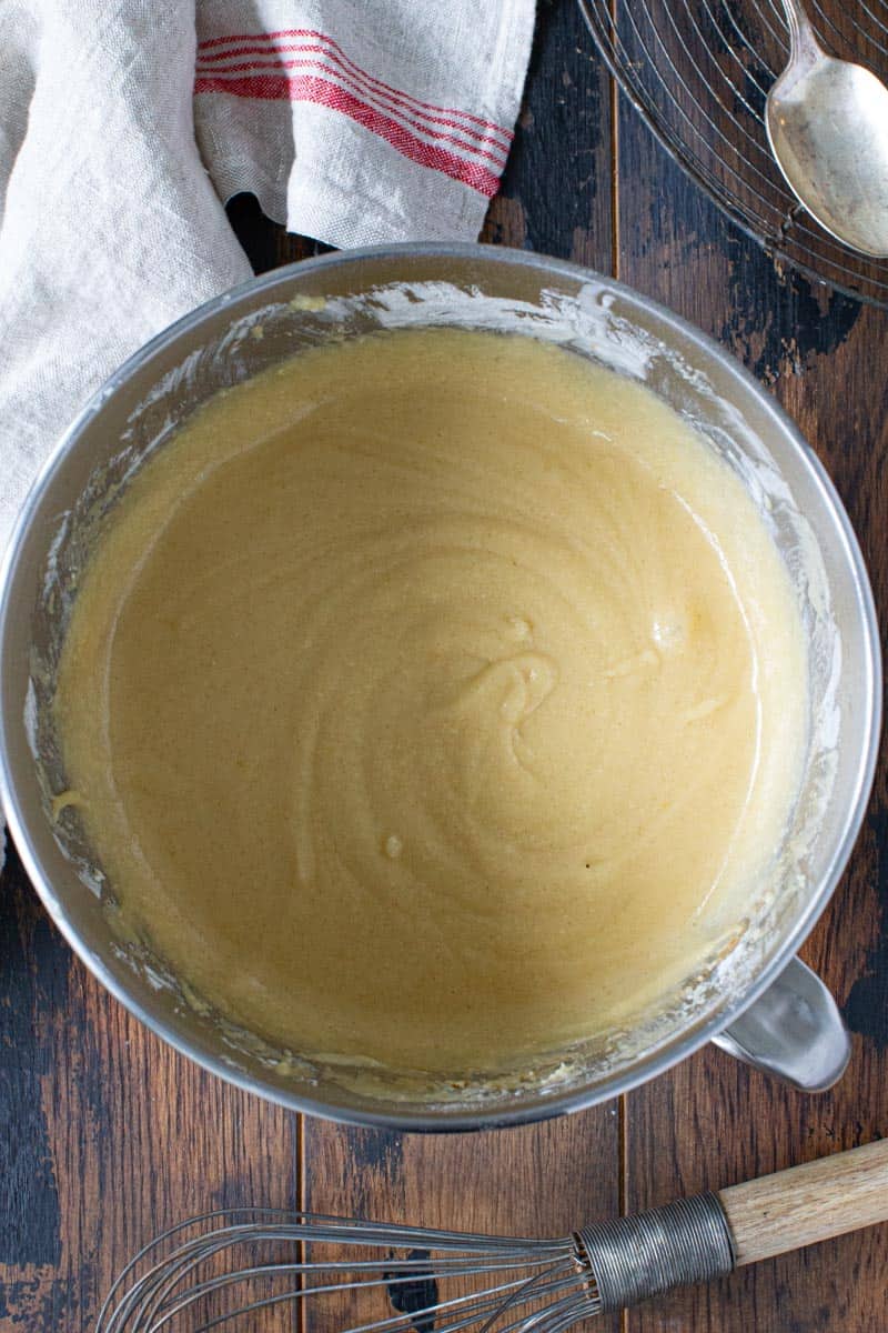 Bundt cake batter in silver mixing bowl.