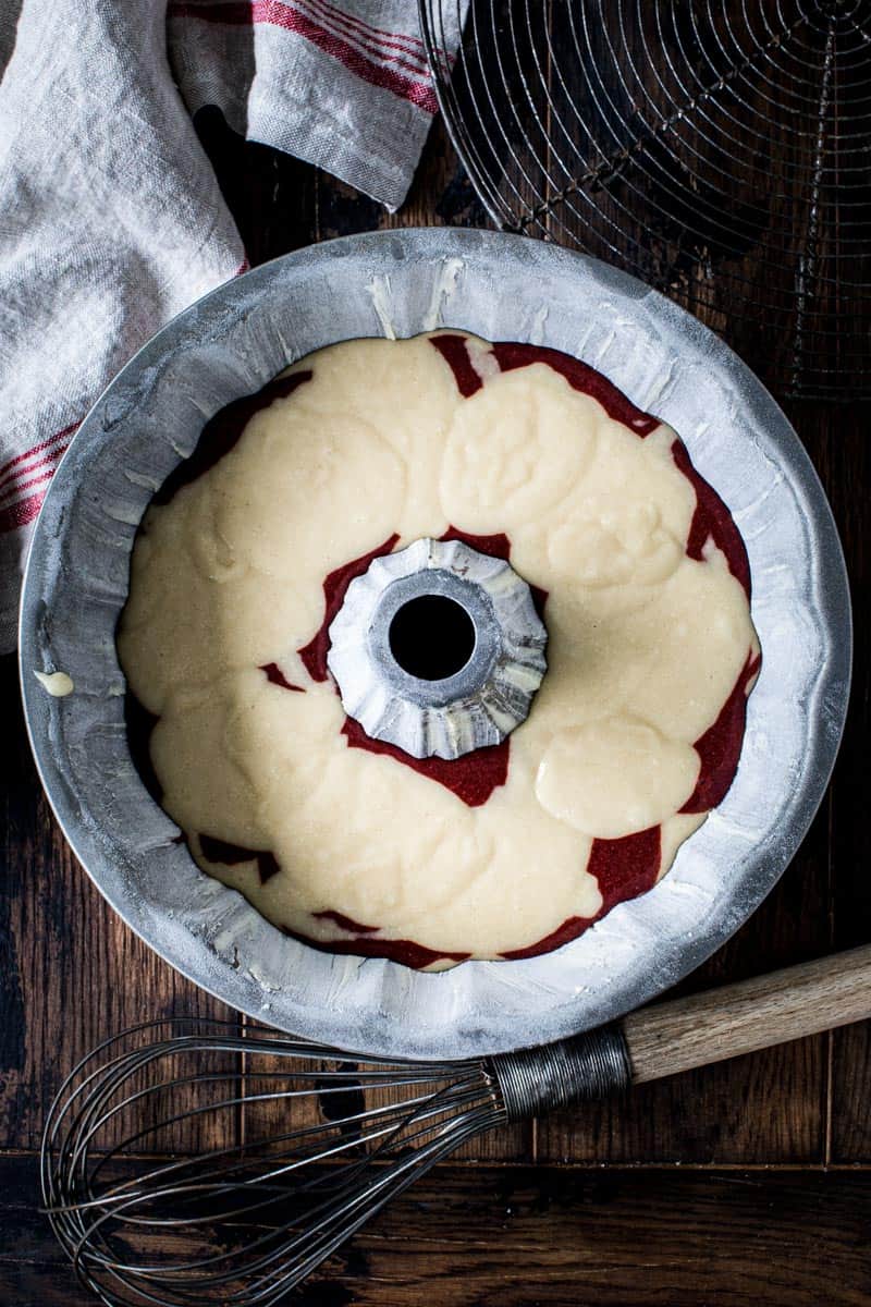 Red velvet bundt cake batter in greased bundt cake pan.