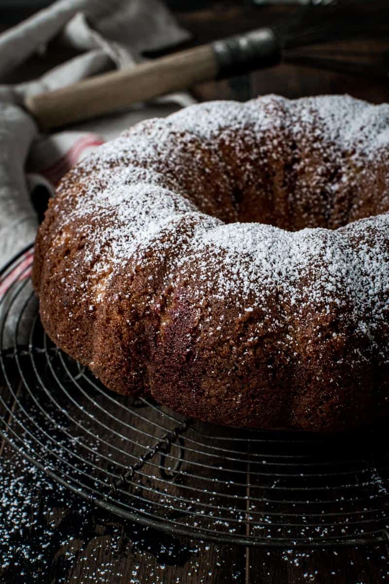 Red velvet marble bundt cake coated in powdered sugar.