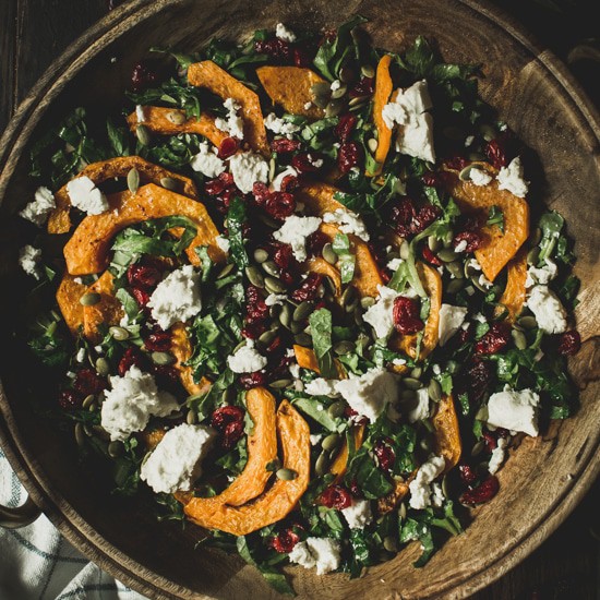 Butternut squash salad in a wooden bowl.
