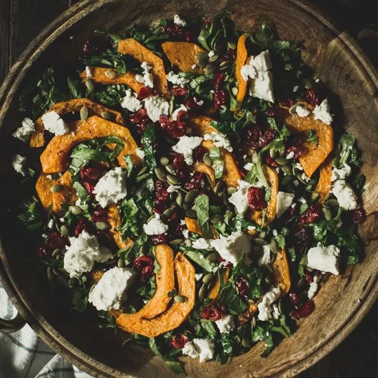 Butternut squash salad in a wooden bowl.