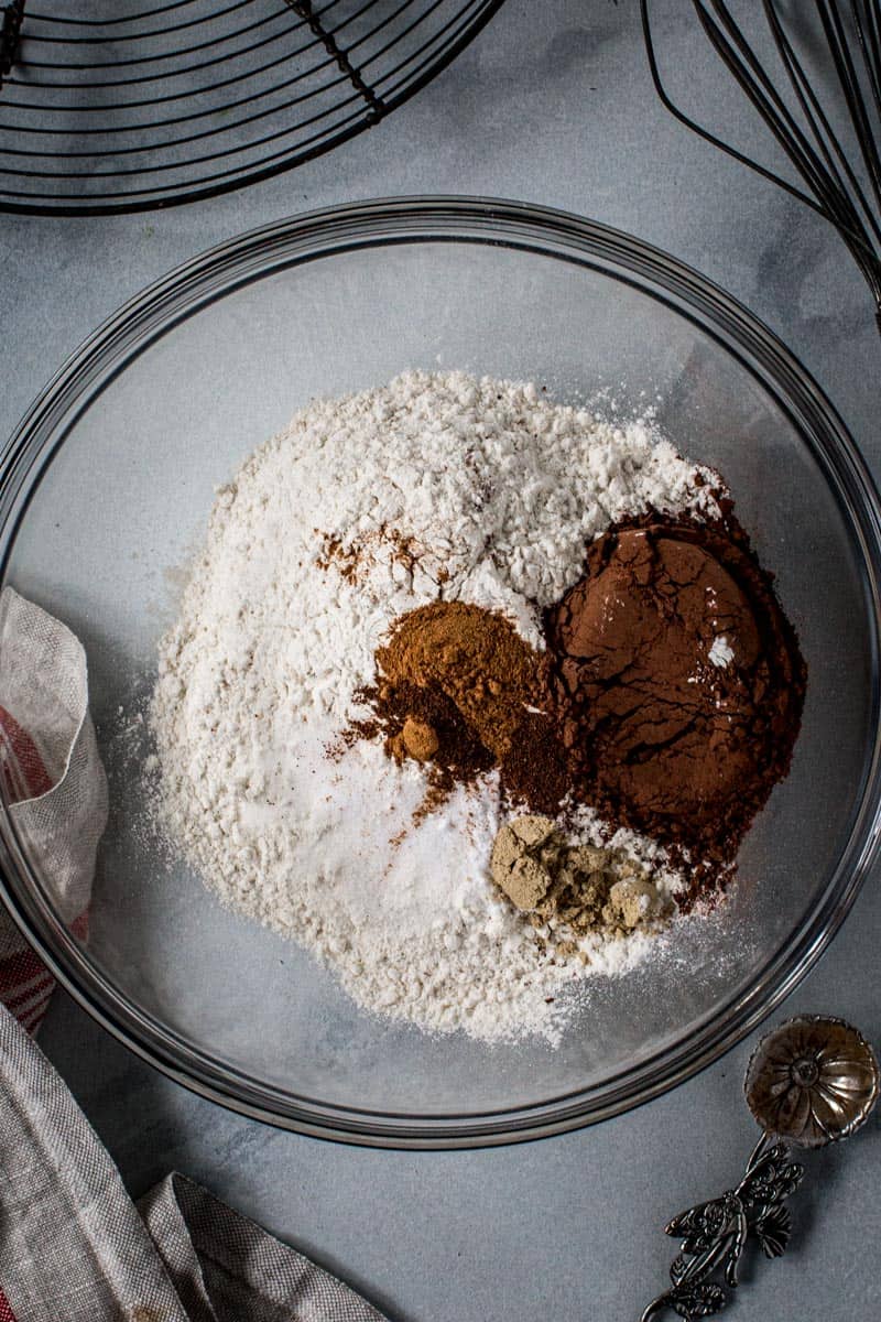 Dry ingredients for soft ginger cookies in a glass mixing bowl.
