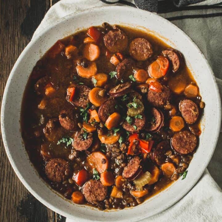 Instant pot sausage and lentil stew in a white bowl.