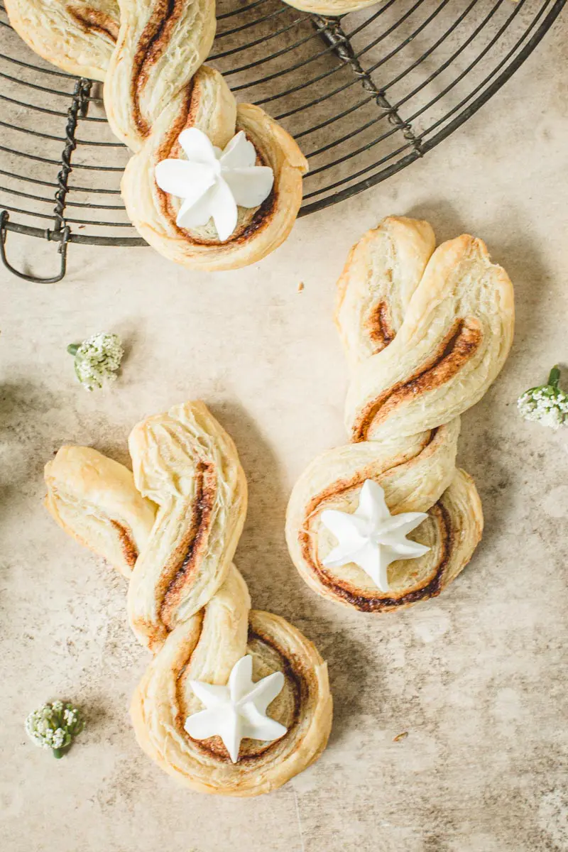 Cinnamon puff pastry twists in Easter bunny shape with a frosting tail.