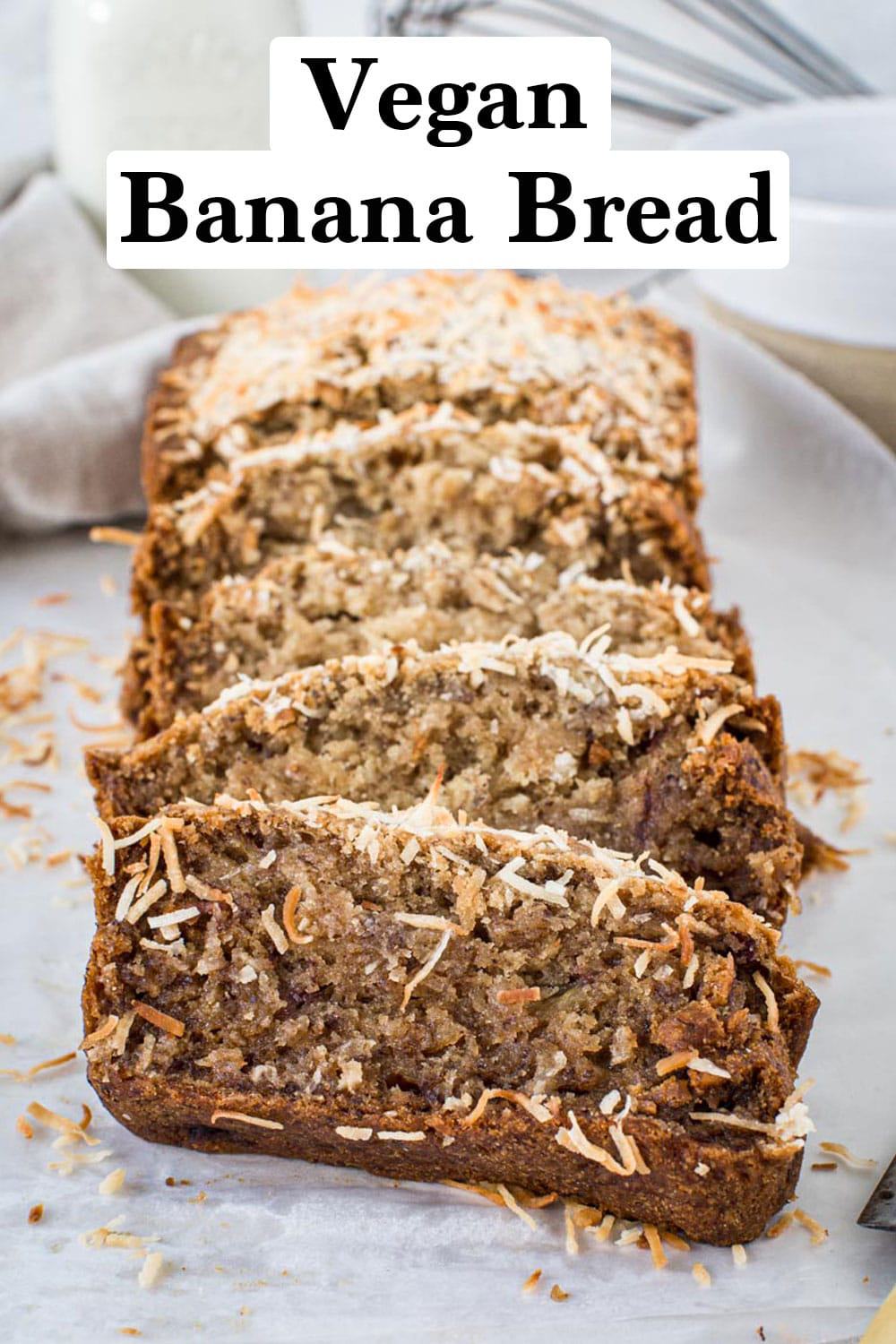 Sliced vegan banana bread topped with coconut flakes.