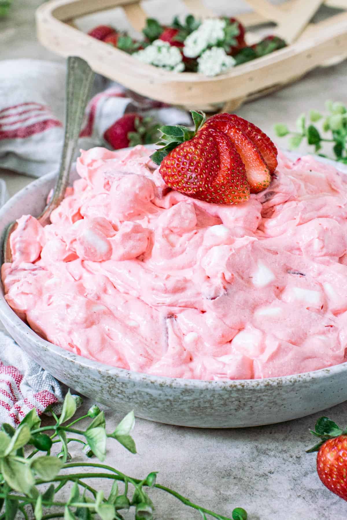 Strawberry jello fluff salad in a bowl.