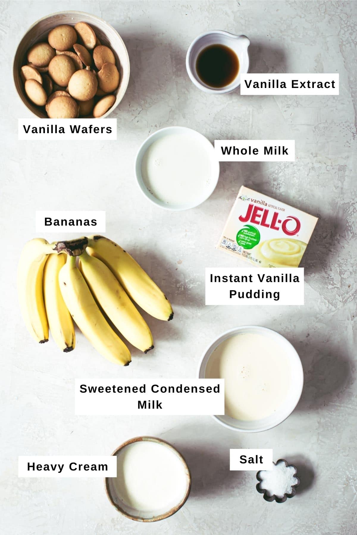 Banana pudding trifle ingredients in different sized bowls.