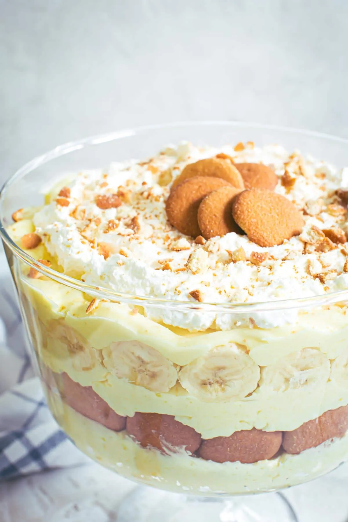 Banana pudding trifle topped with vanilla wafers and whipped cream.