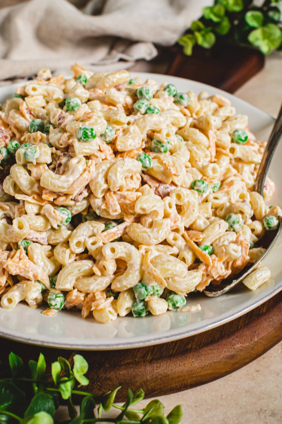 Bacon ranch pasta salad with peas in a bowl.