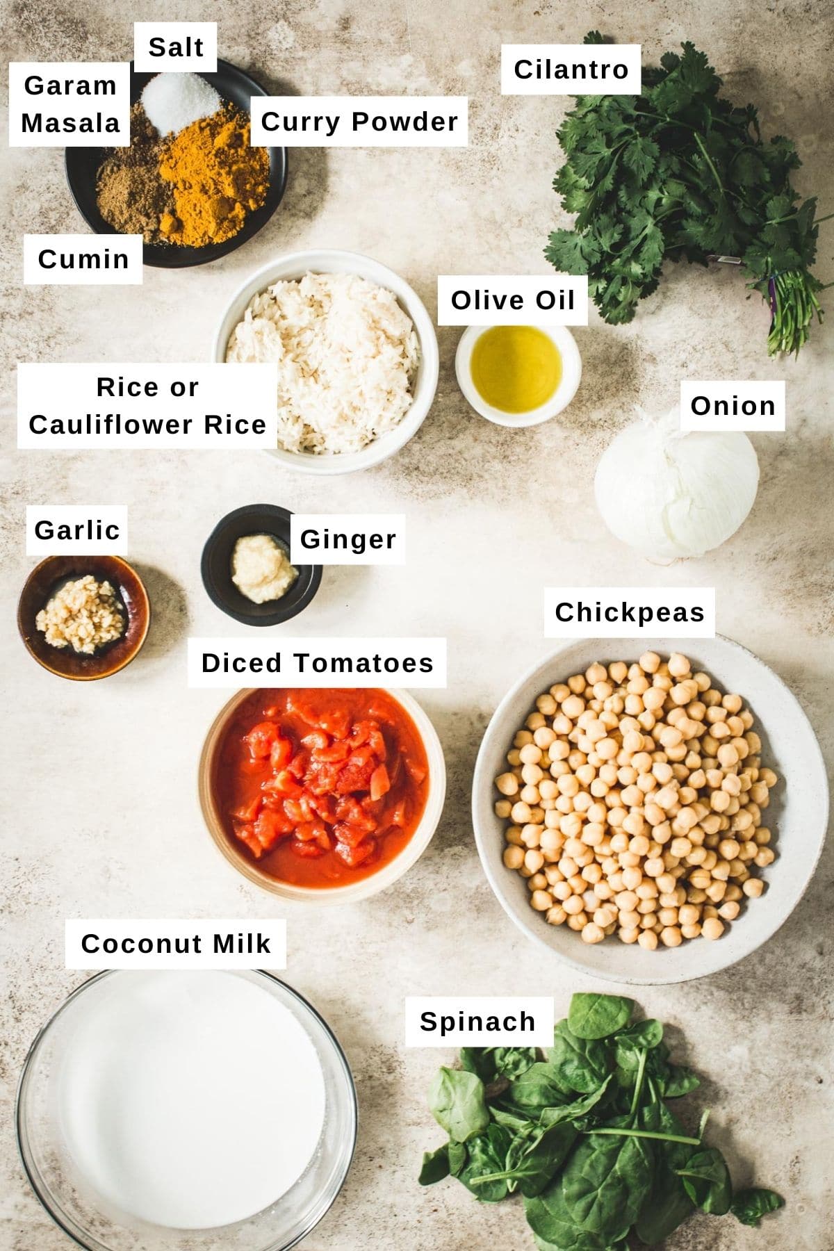 Chickpea spinach curry ingredients in different bowls.