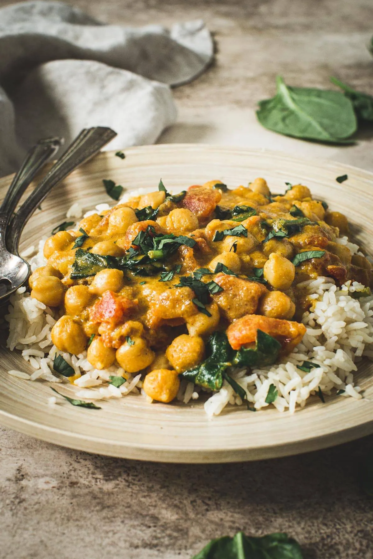 Chickpea spinach curry topped with cilantro and served over rice.