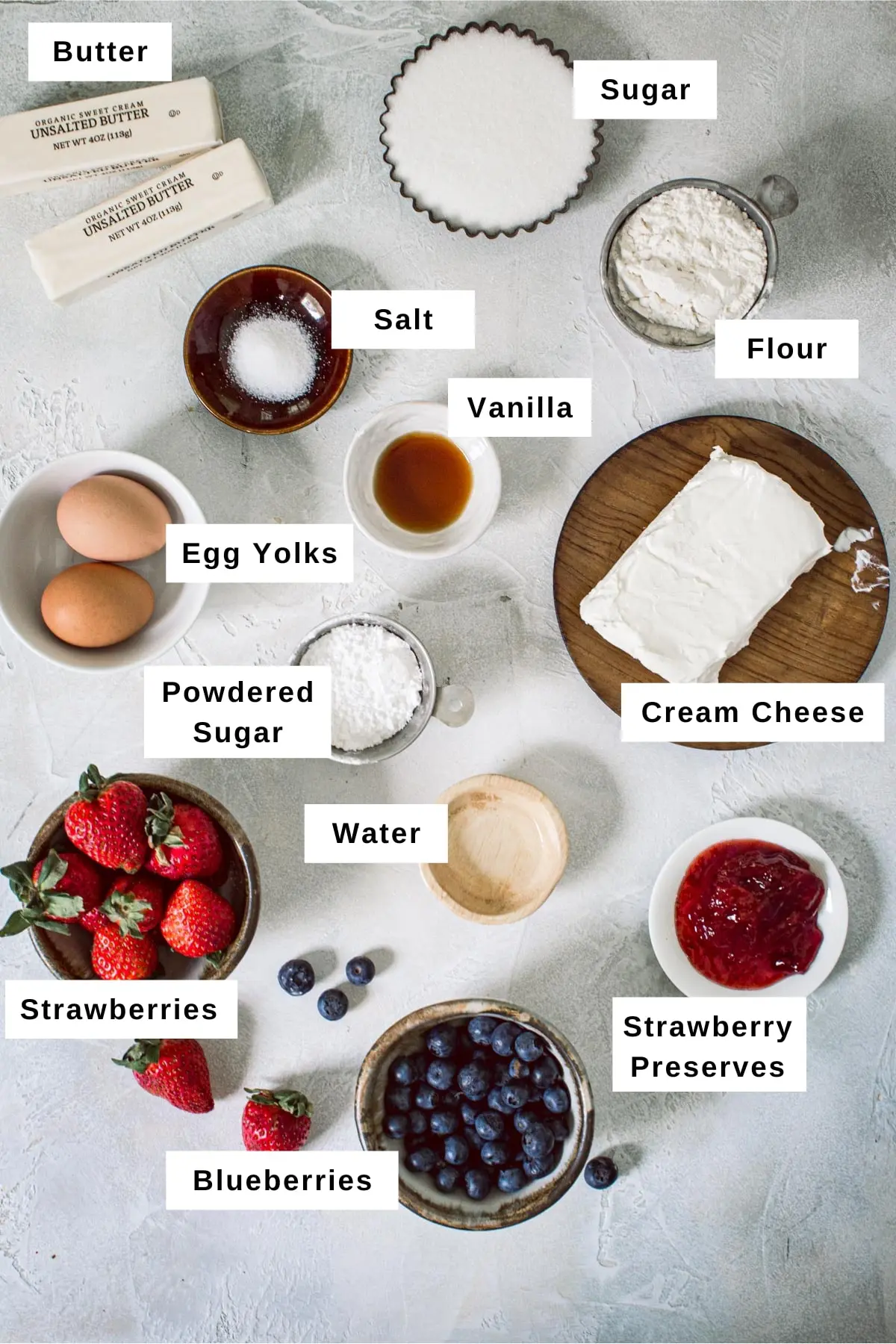 Ingredients for making Fourth of July fruit pizza in different sized bowls.