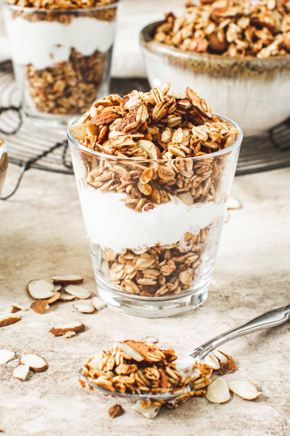 Honey vanilla granola parfait with spoon holding granola in front.