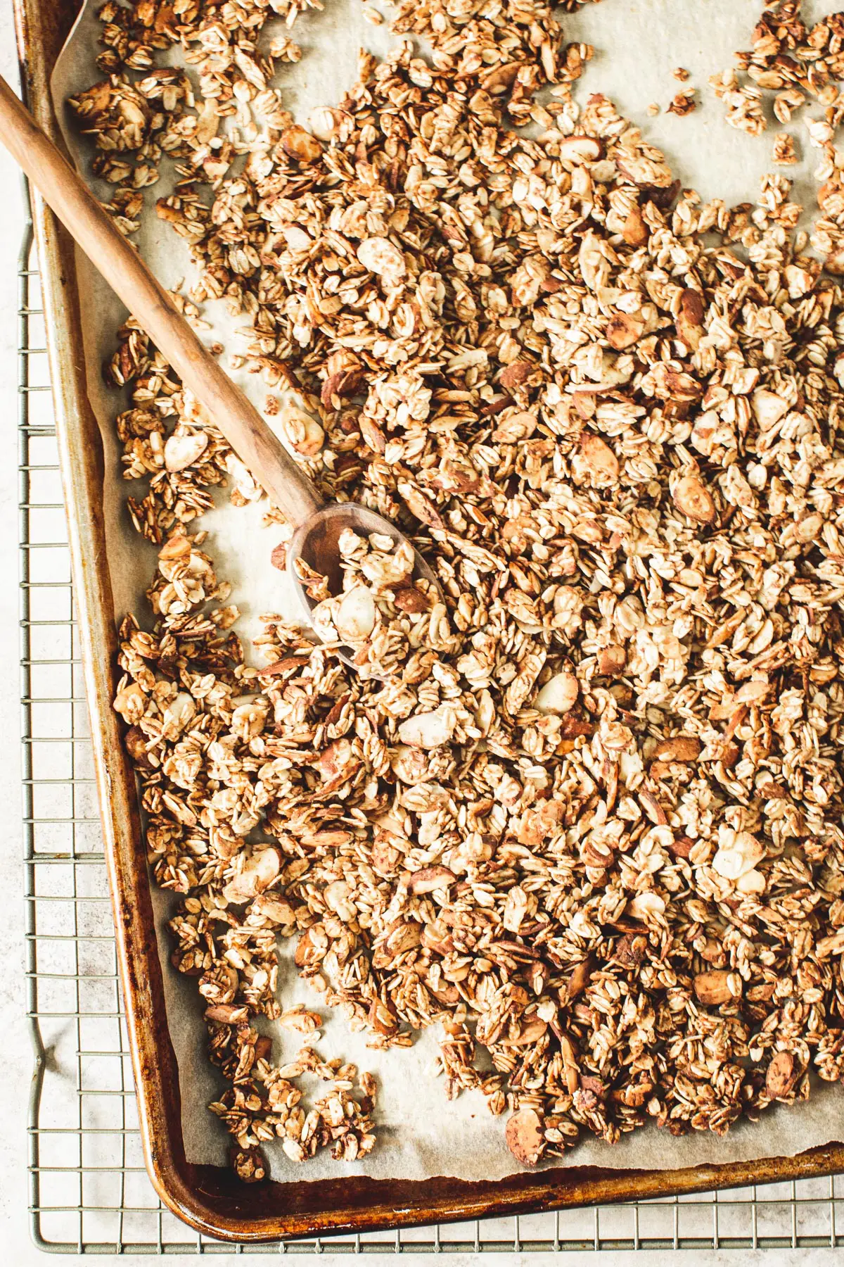 Honey vanilla granola recipe on a rimmed baking sheet.