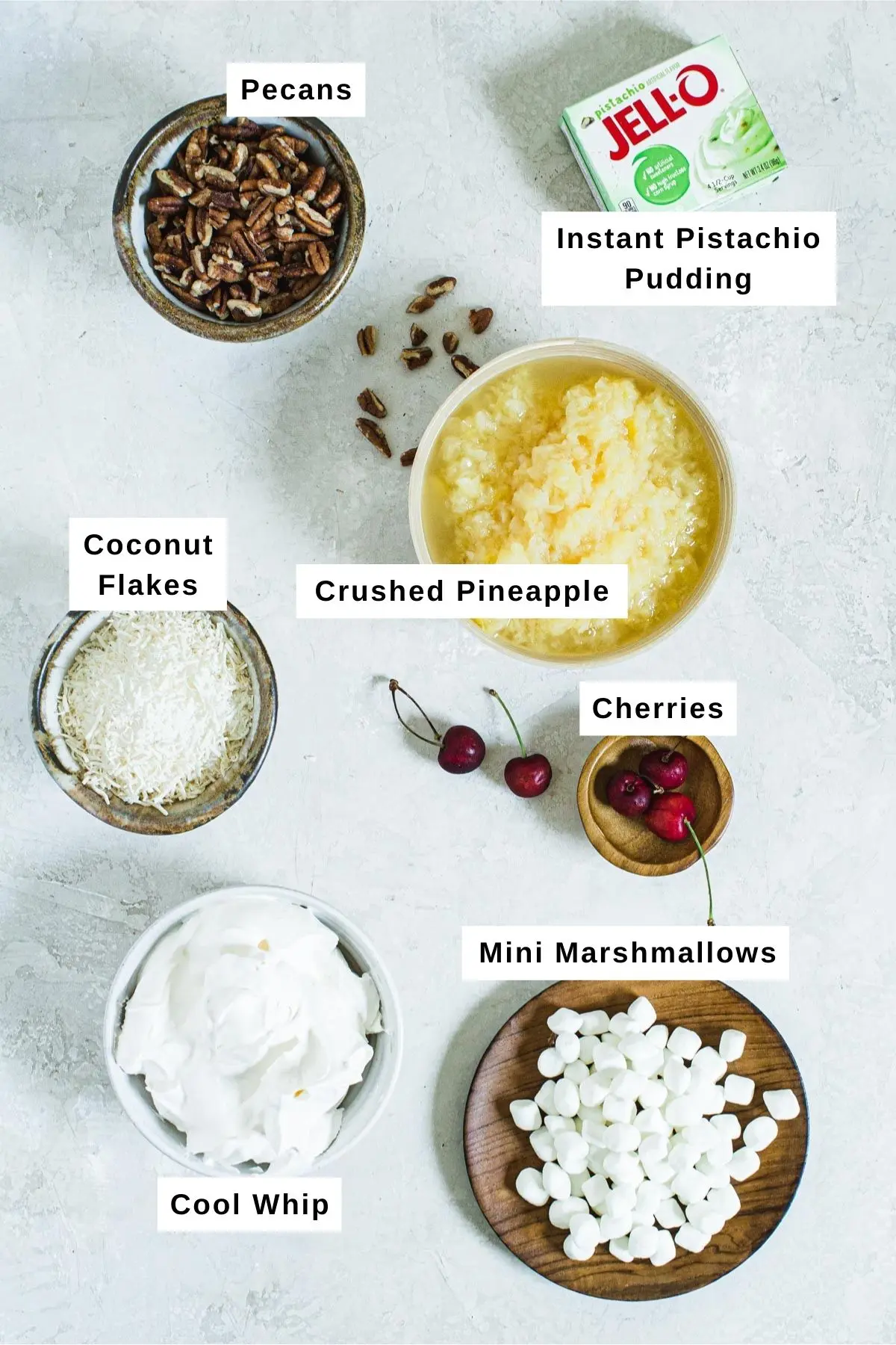 Pistachio pudding salad ingredients in different bowls.