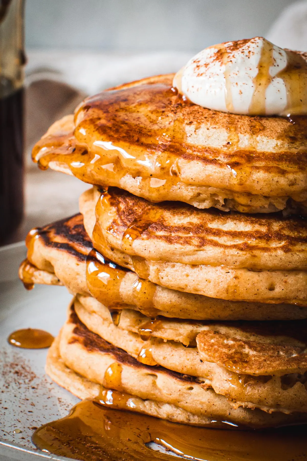 Stacked sweet potato pancakes drizzled in syrup. 