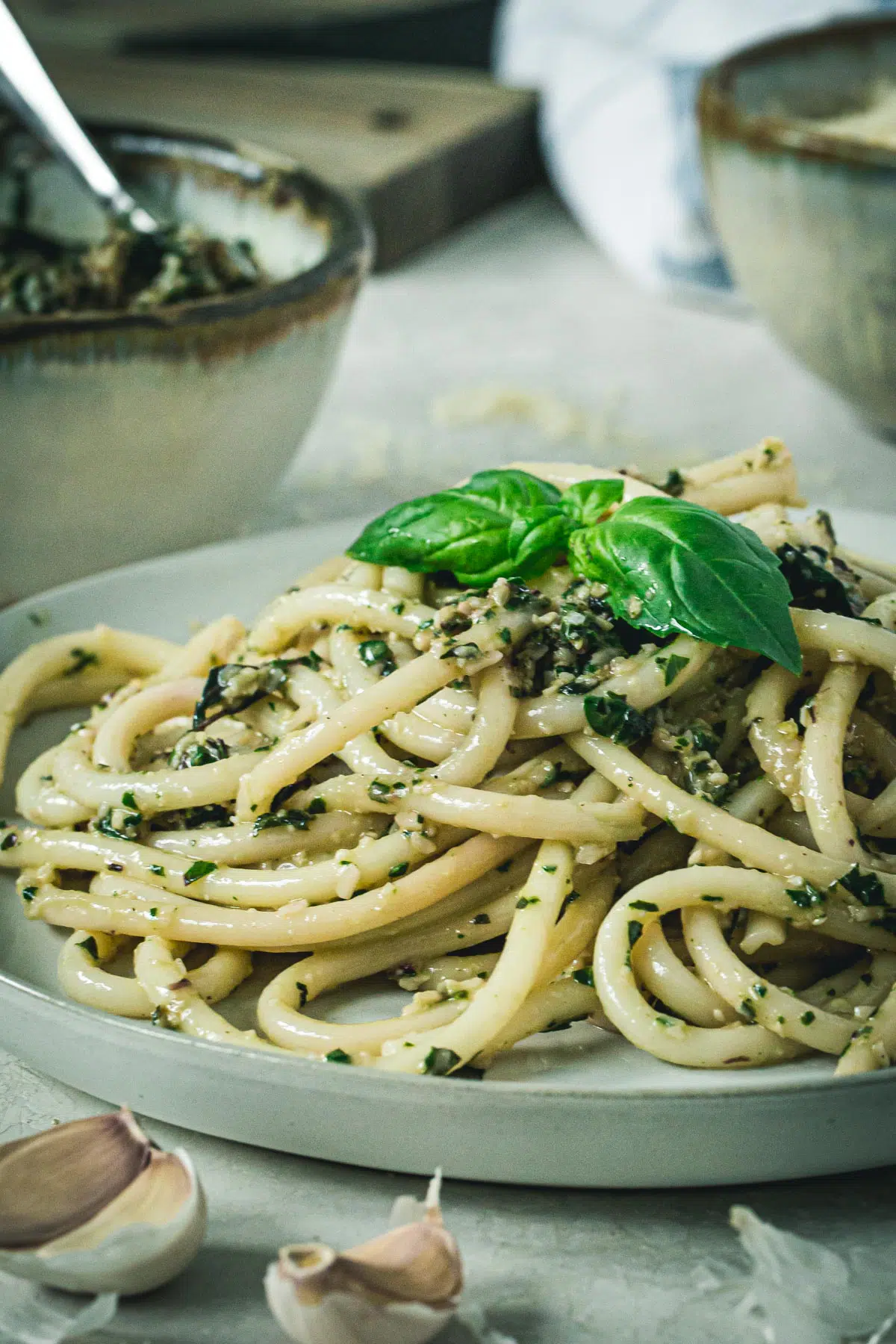 Beet greens pesto pasta on a white plate.