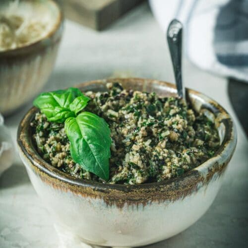Homemade beet greens pesto in a pottery bowl.