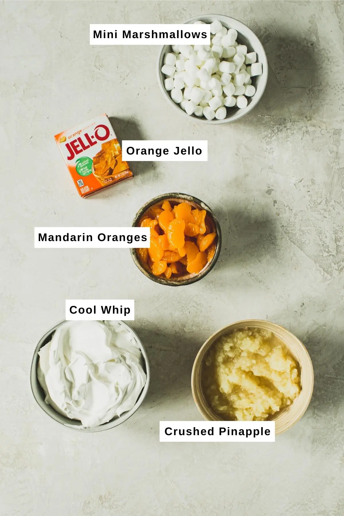 Orange Jello salad ingredients in bowls.