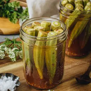 Quick pickled okra in a glass jar.