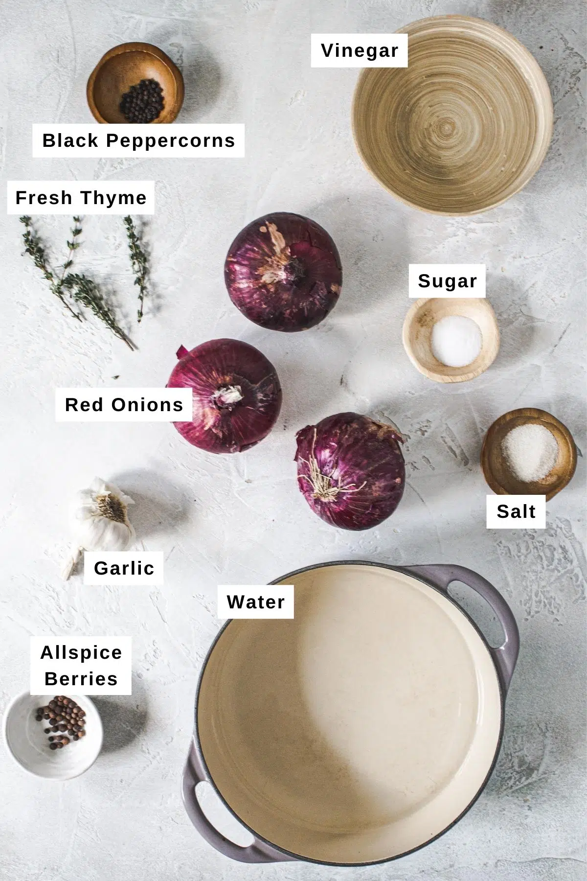 Pickled red onions ingredients in bowls on a table.