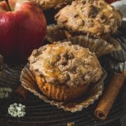 Apple crumble muffins on a wire rack.