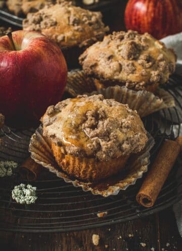 Apple crumble muffins on a wire rack.