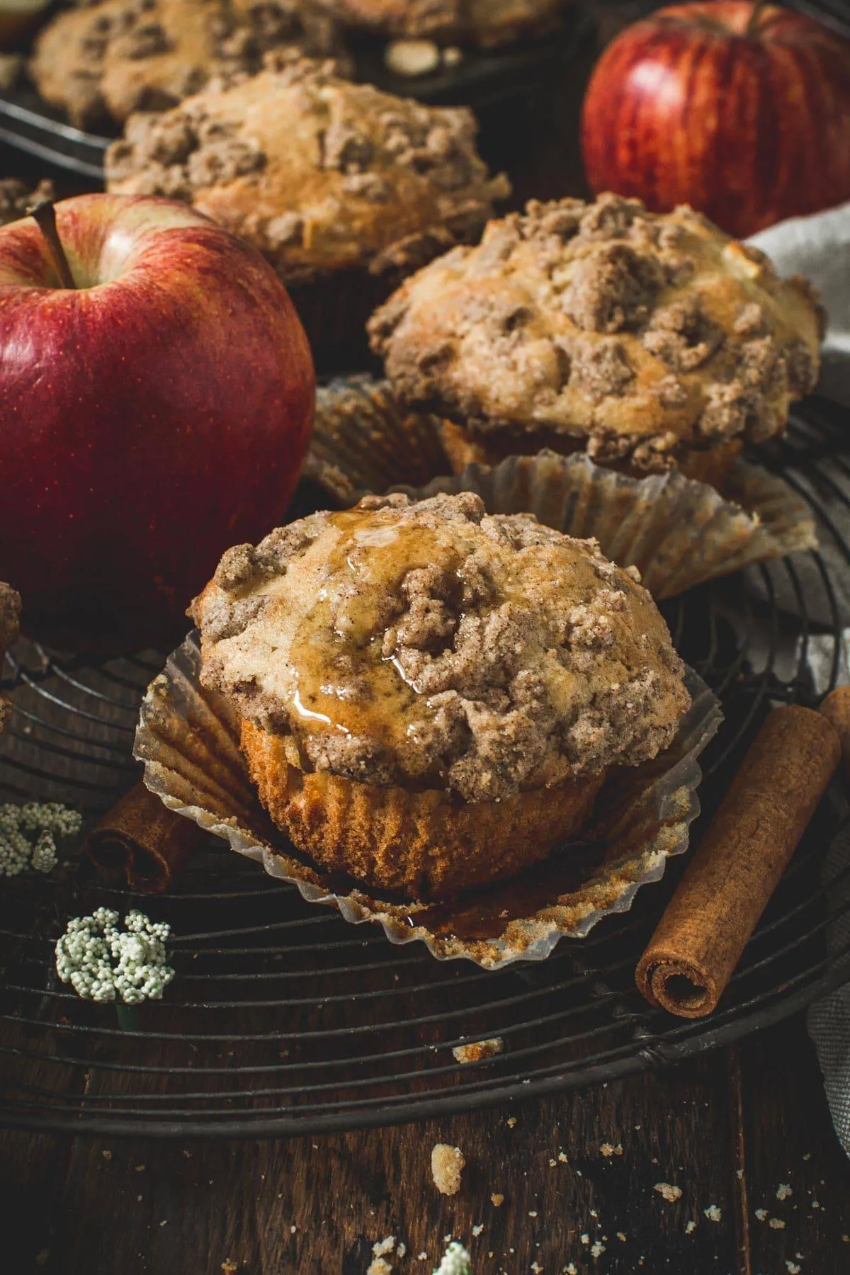 Apple crumble muffin with honey drizzled on top.