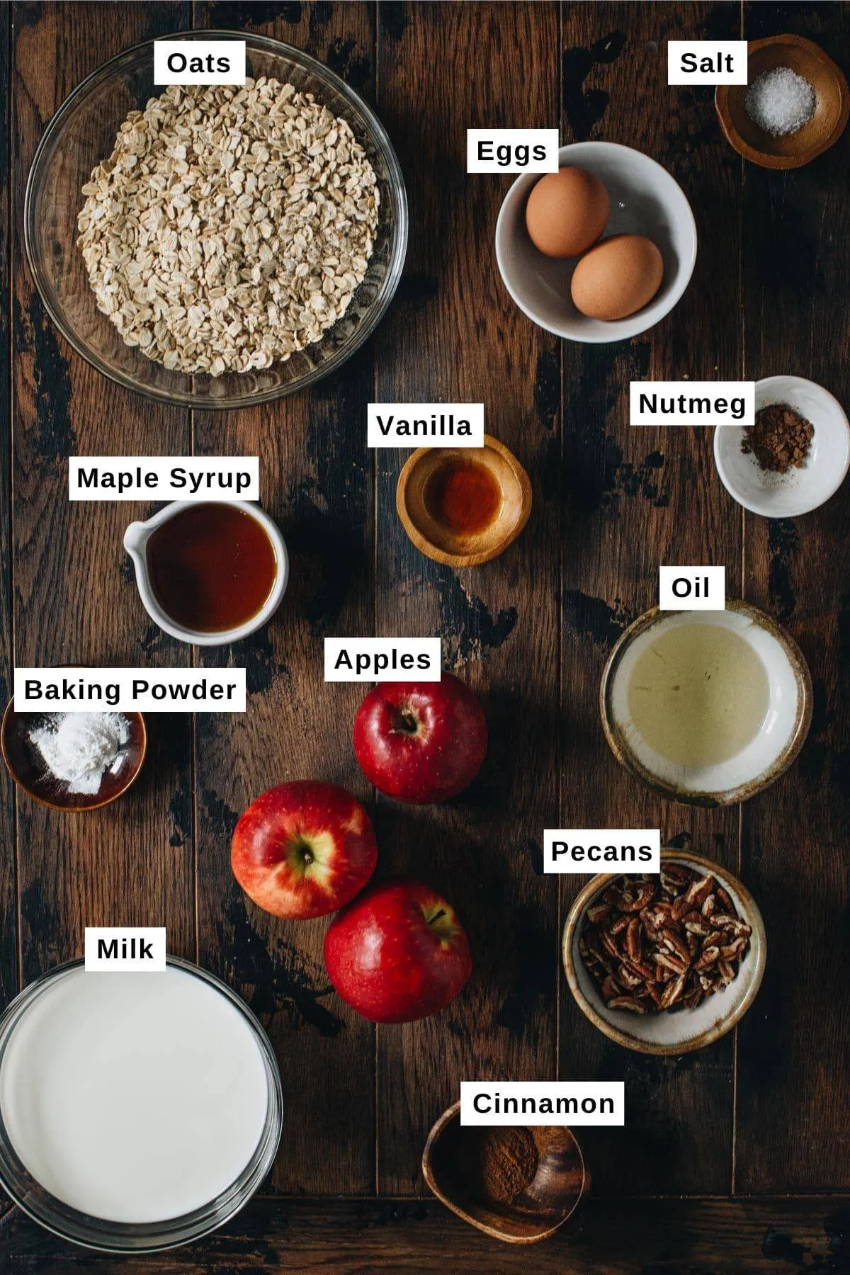 Apple cinnamon baked oatmeal ingredients on a wooden table.