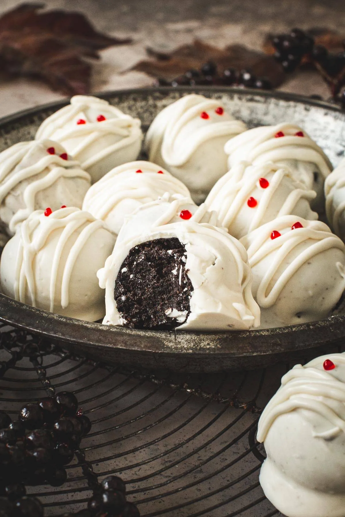 Oreo cookie ball with a bite taken out of it sitting on top of other balls.