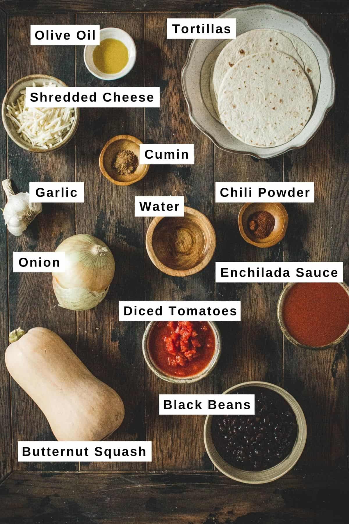 Butternut squash enchilada ingredients on a wooden table.