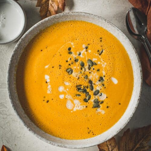 Curried pumpkin soup topped with coconut milk and pumpkin seeds.