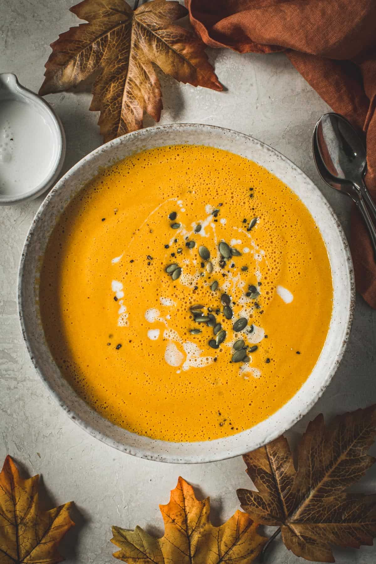 Curried pumpkin soup topped with coconut milk and pumpkin seeds.