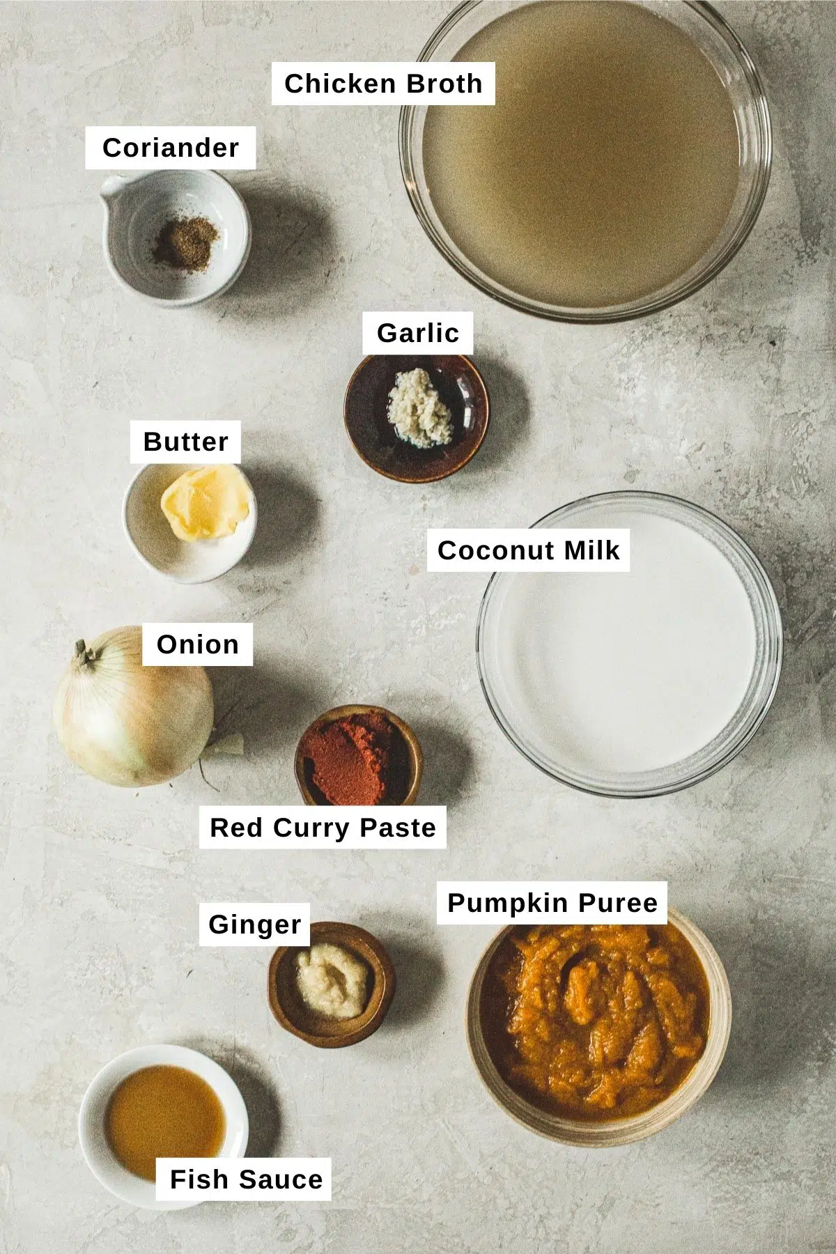 Curried pumpkin soup ingredients in bowls.