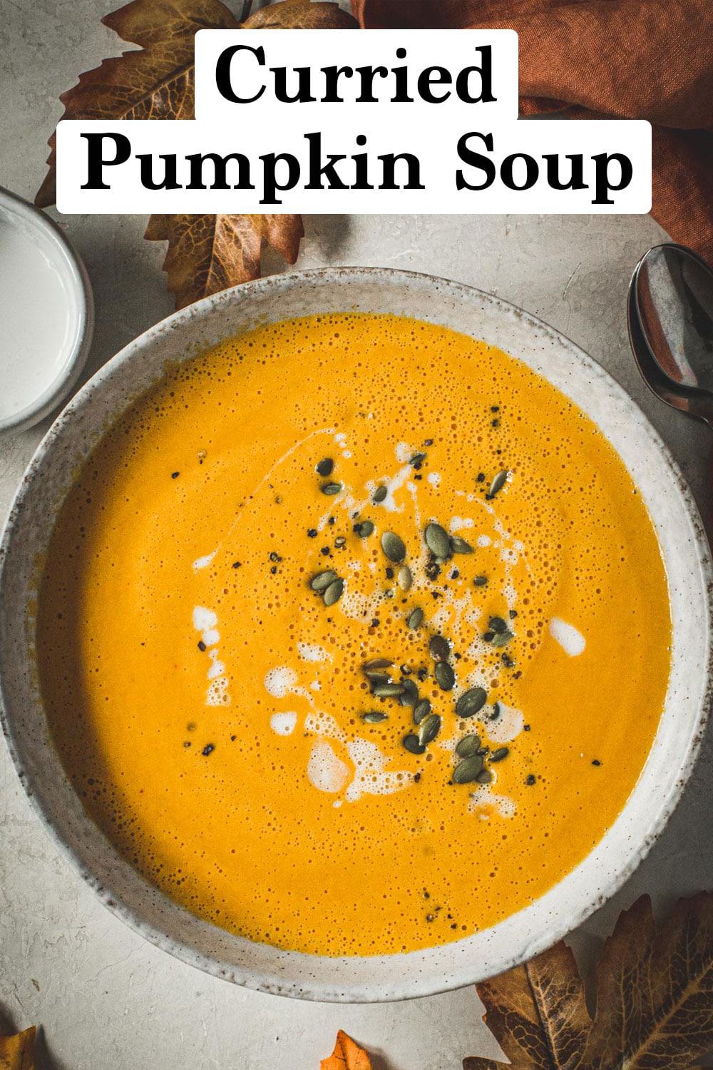 Curried pumpkin soup with pumpkin seeds on top.