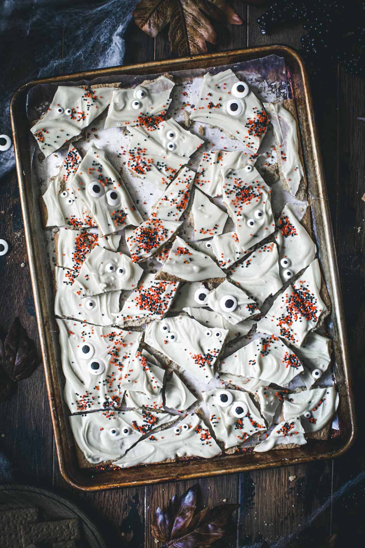 Halloween almond bark pieces on a rimmed baking sheet.