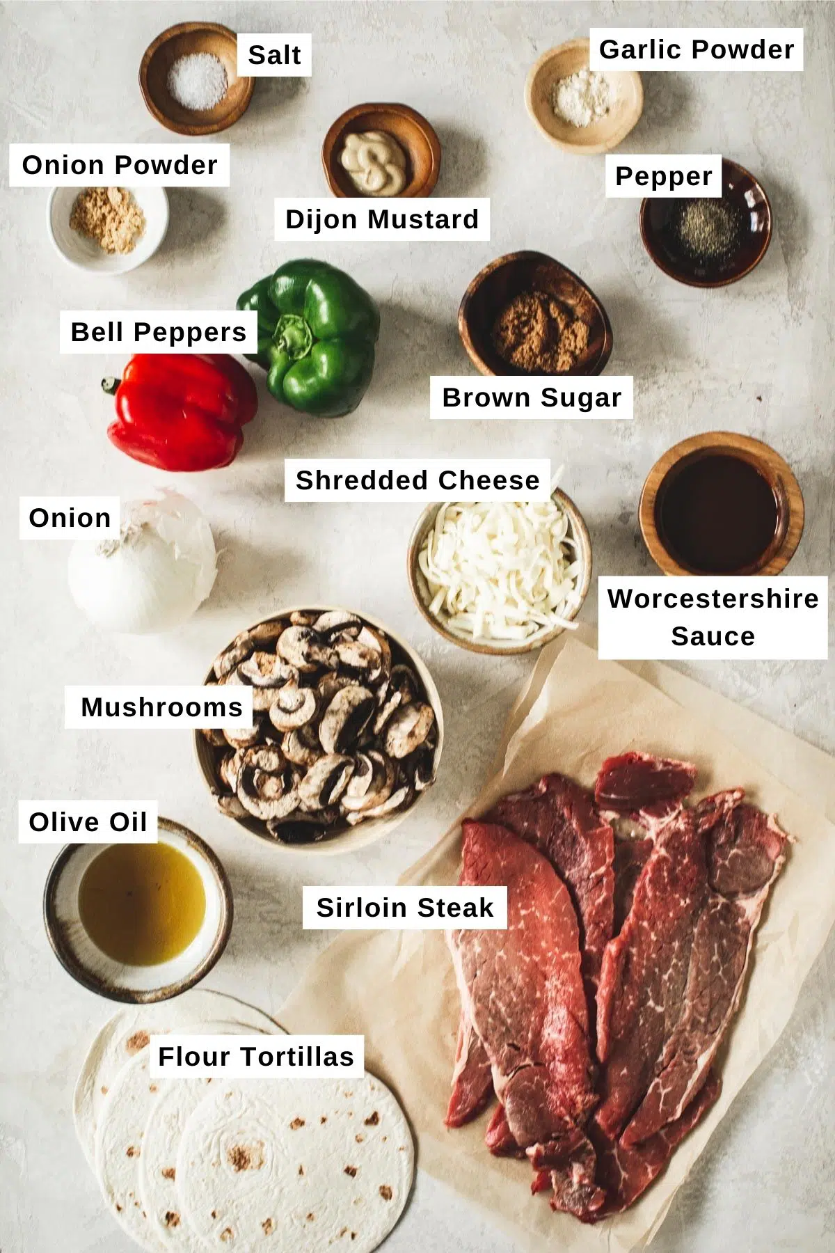 Cheesesteak ingredients in bowls.