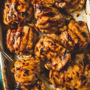 Huli huli chicken on a white tray.