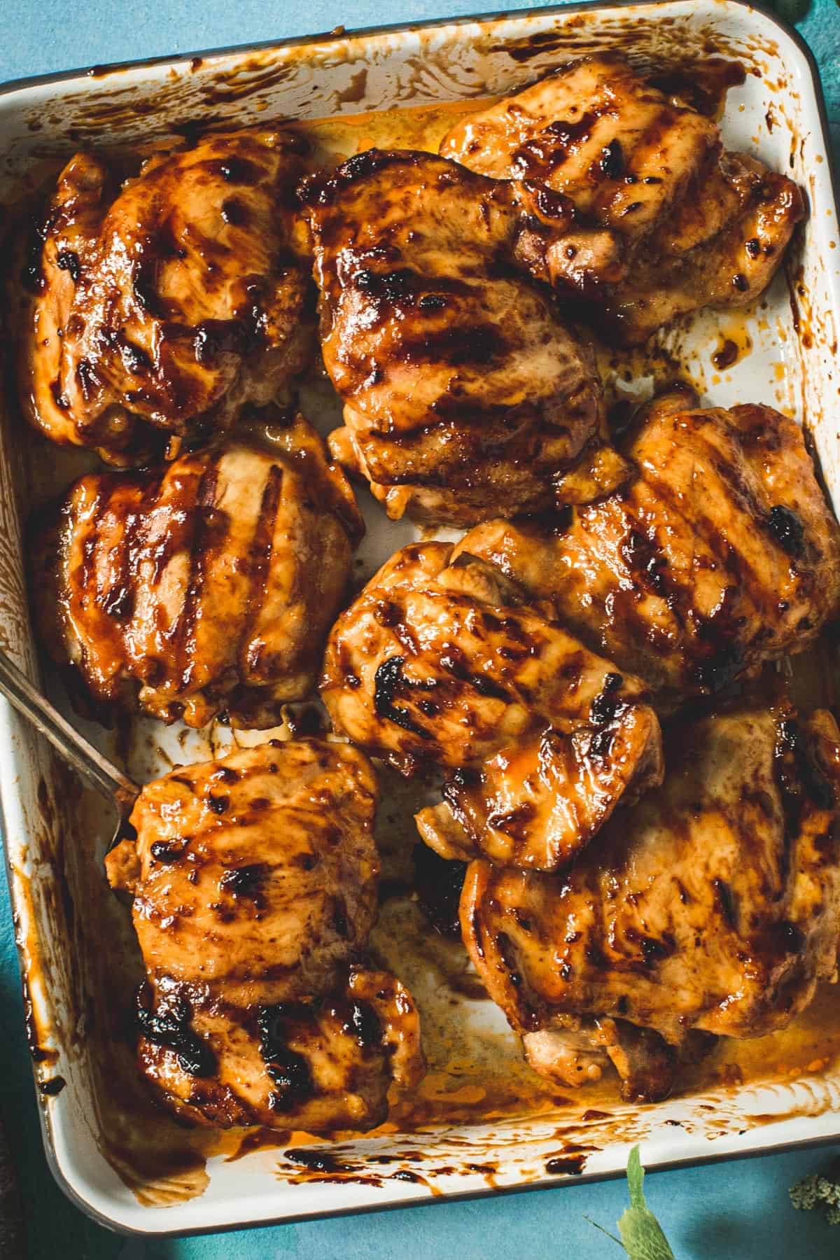 Huli huli chicken on a white tray.