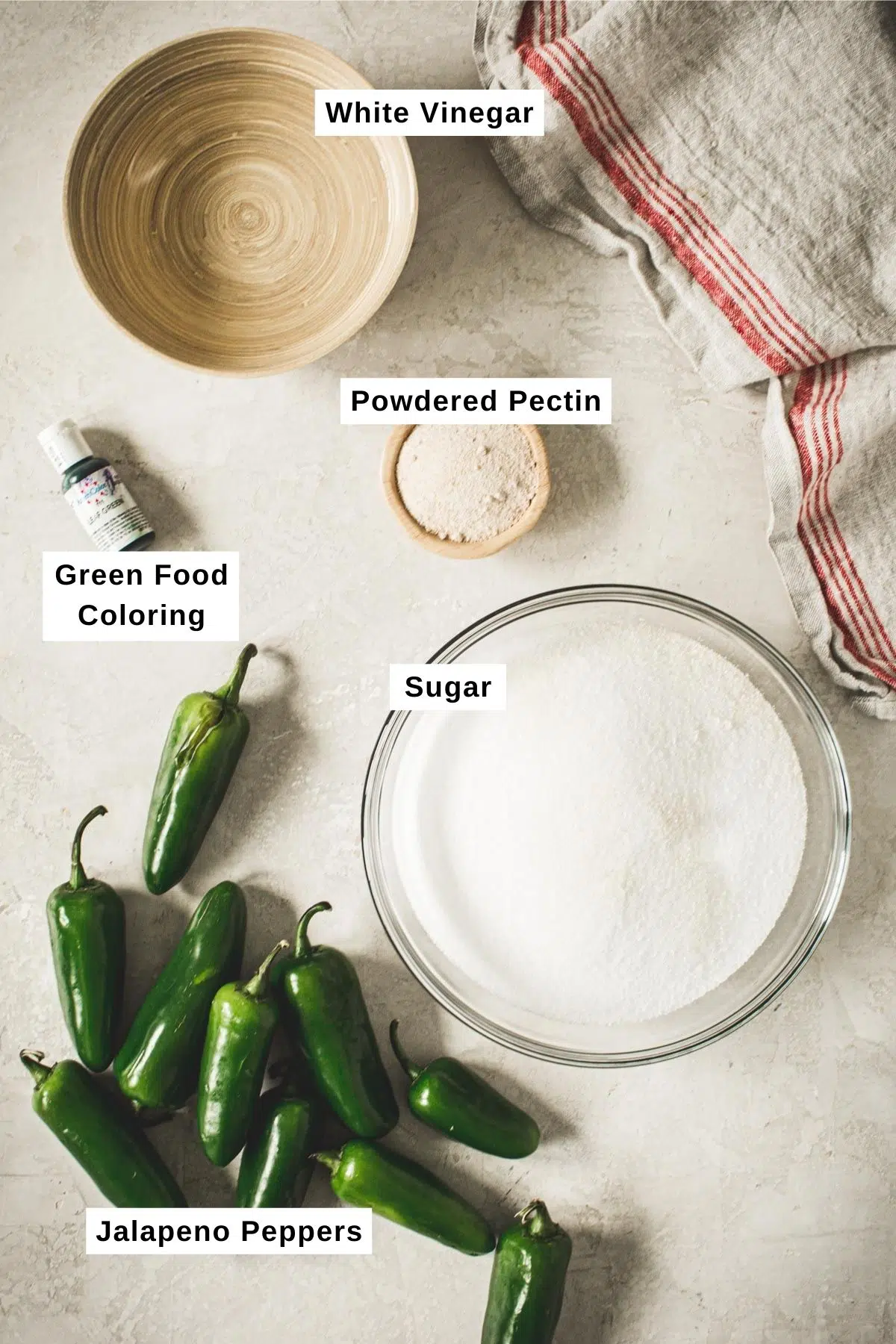 Jalapeno pepper jelly ingredients on a white table.