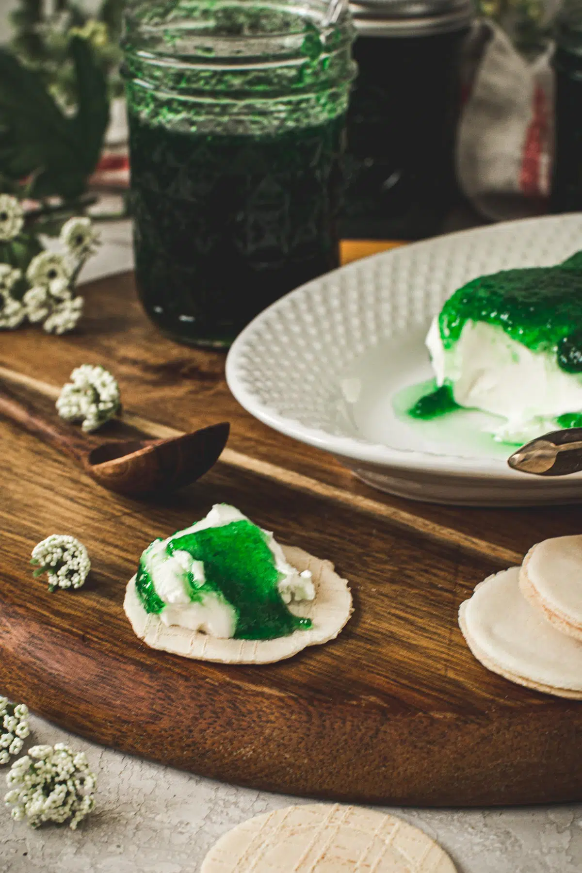 Jalapeno pepper jelly over cream cheese on a cracker.