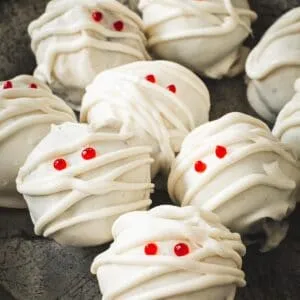 Mummy Oreo cookie balls with red eyes.