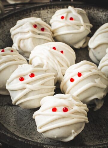 Mummy Oreo cookie balls with red eyes.