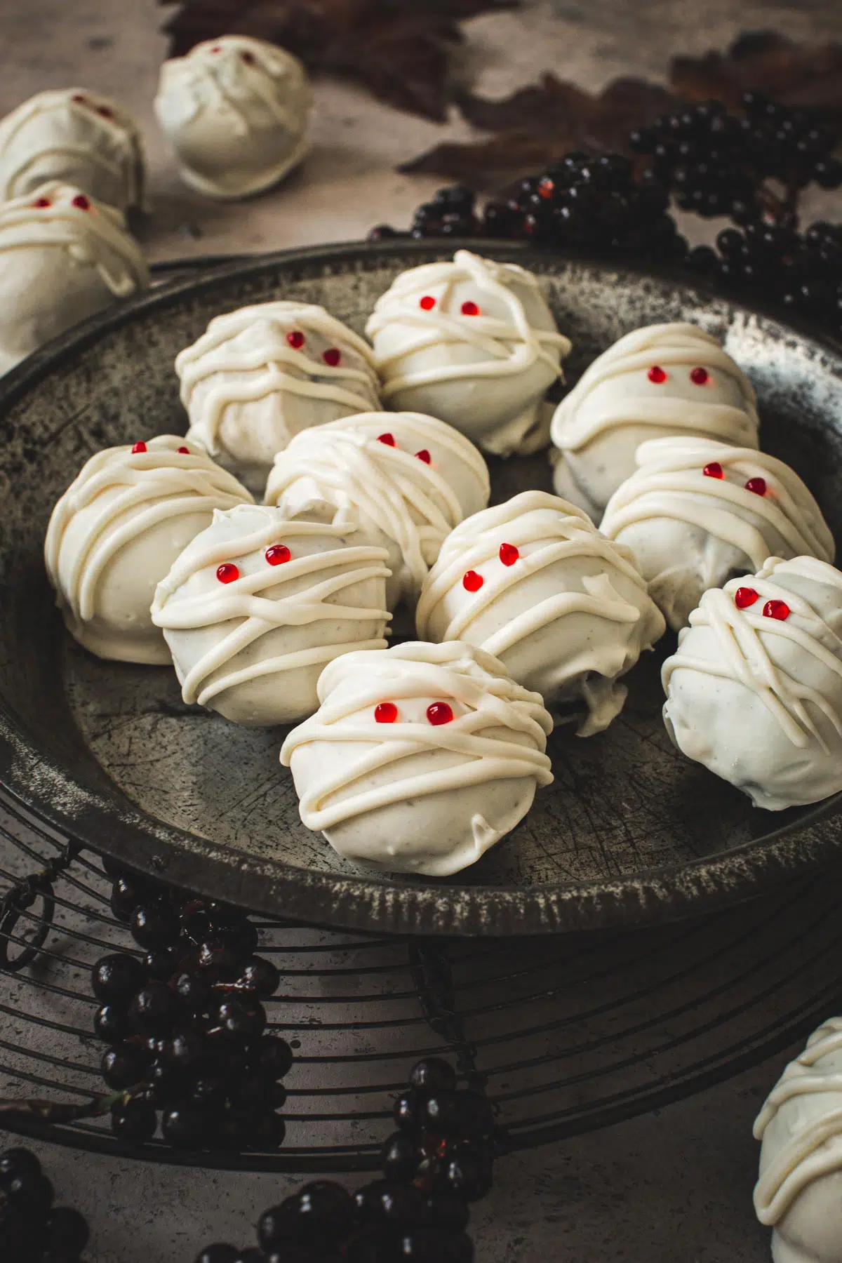 Mummy Oreo cookie balls in a metal pie tin.