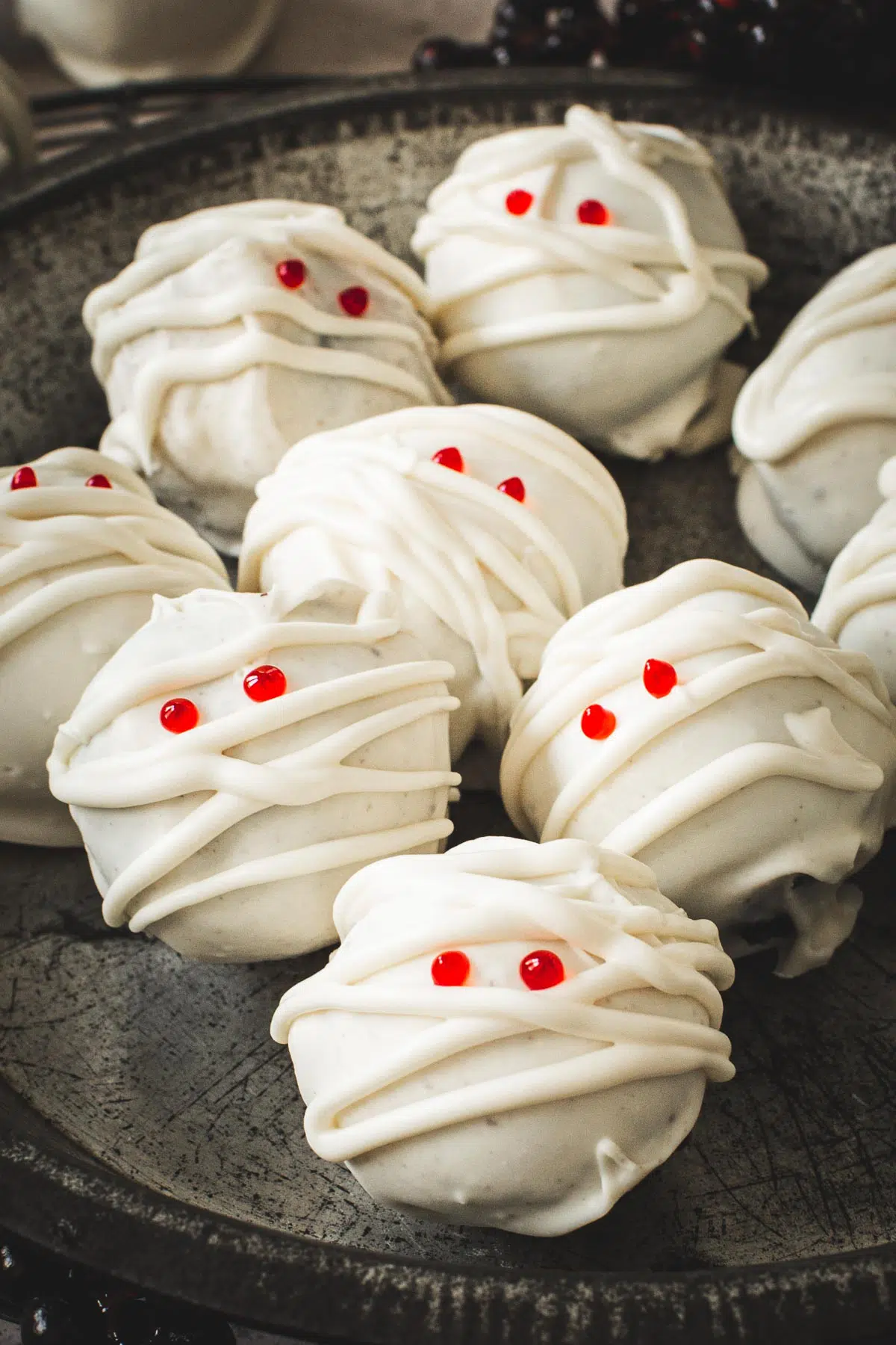 Mummy Oreo cookie balls with red eyes.