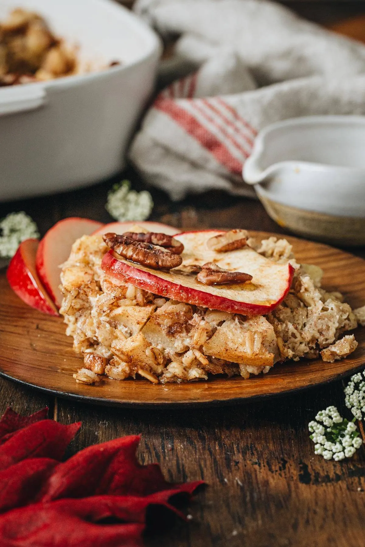 Piece of apple cinnamon baked oatmeal on a wooden plate.