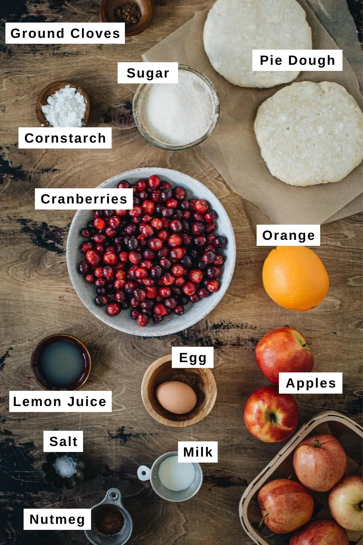 Apple cranberry pie ingredients in various bowls.